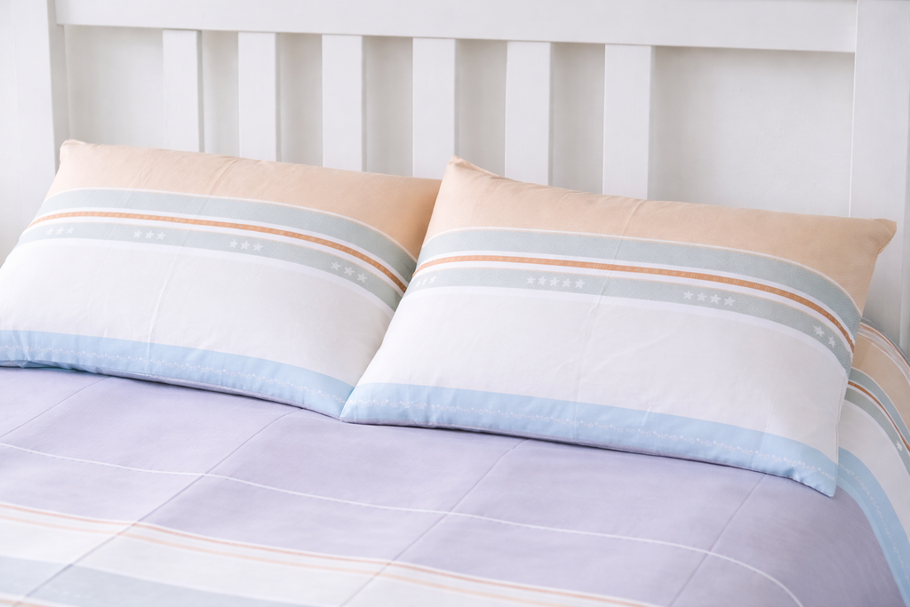 Striped bedding set with pillows on a bed
